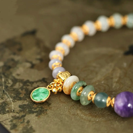 Close-up of natural tri-color jadeite abacus beads with gold-plated spacers, showing vibrant green translucency