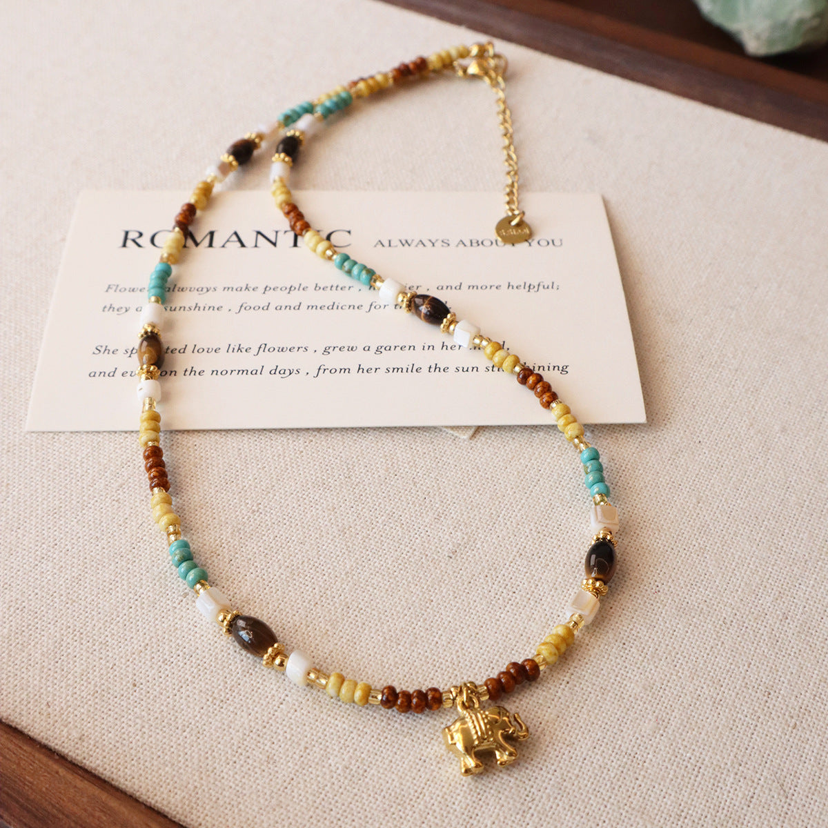 Detail of elephant charm on mixed natural stone necklace