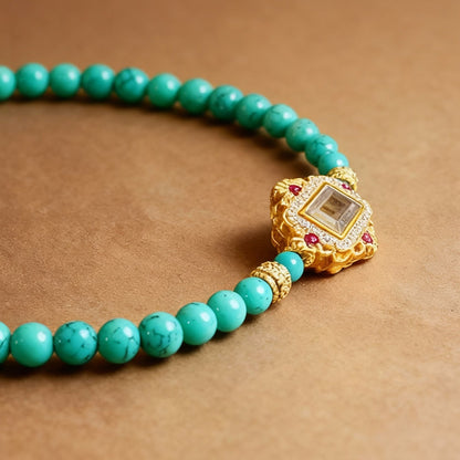 Close-up of turquoise beads with white pearl accents on bracelet
