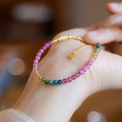 Candy-colored tourmaline beaded bracelet with gold accent bead