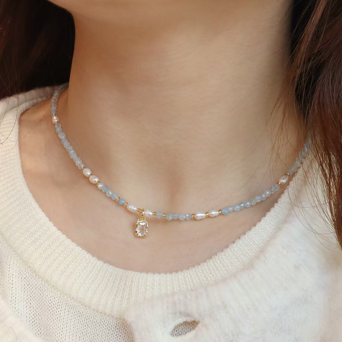 Close-up of aquamarine beads with white pearl accents on necklace
