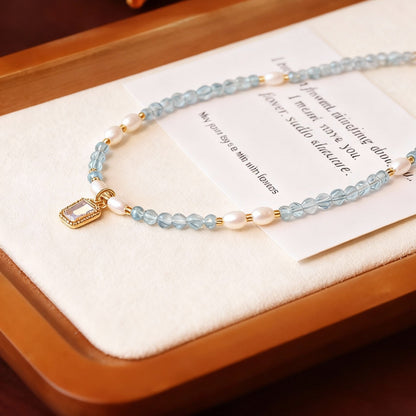 Natural aquamarine necklace showing blue crystal and pearl combination