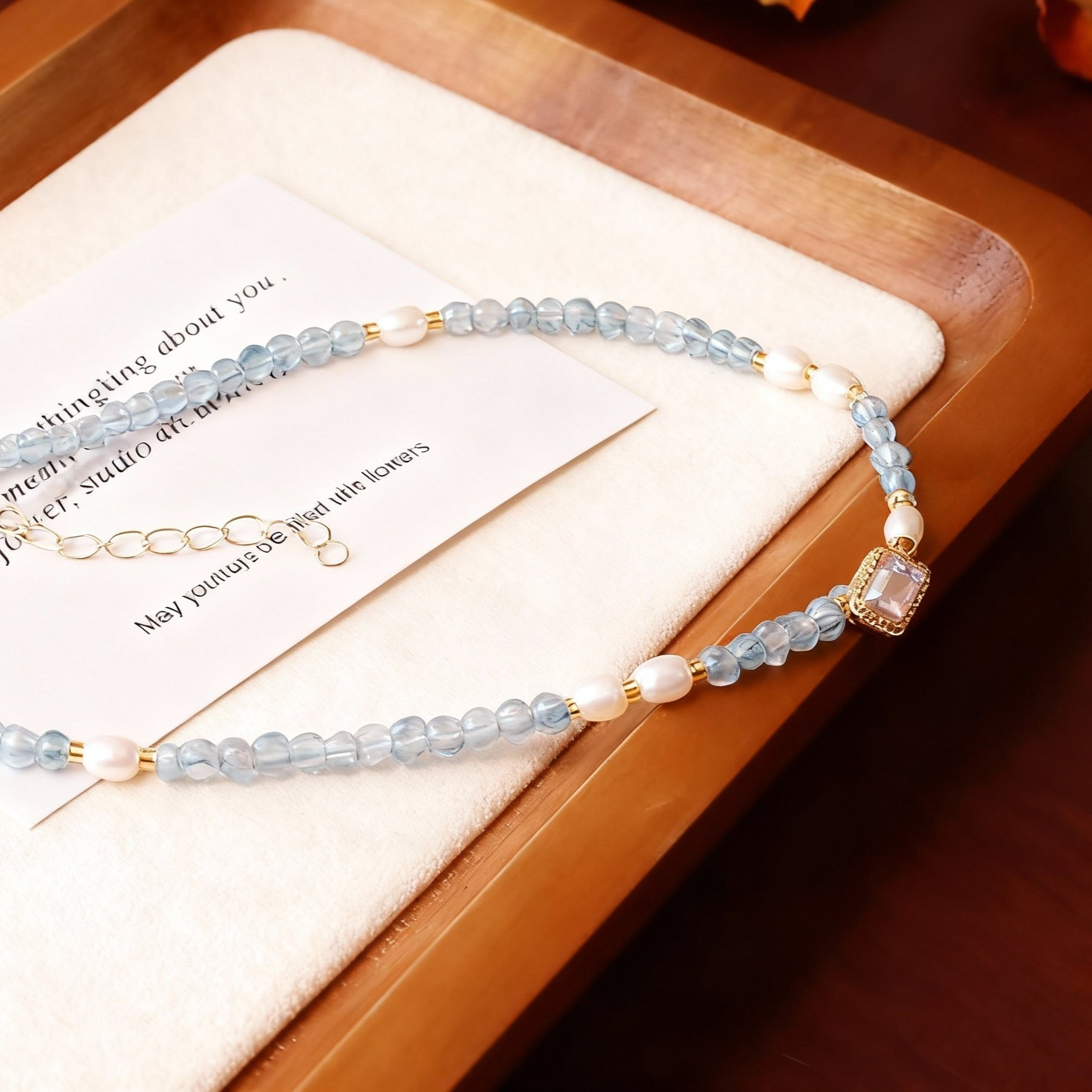 Blue aquamarine and white pearl beaded necklace detail