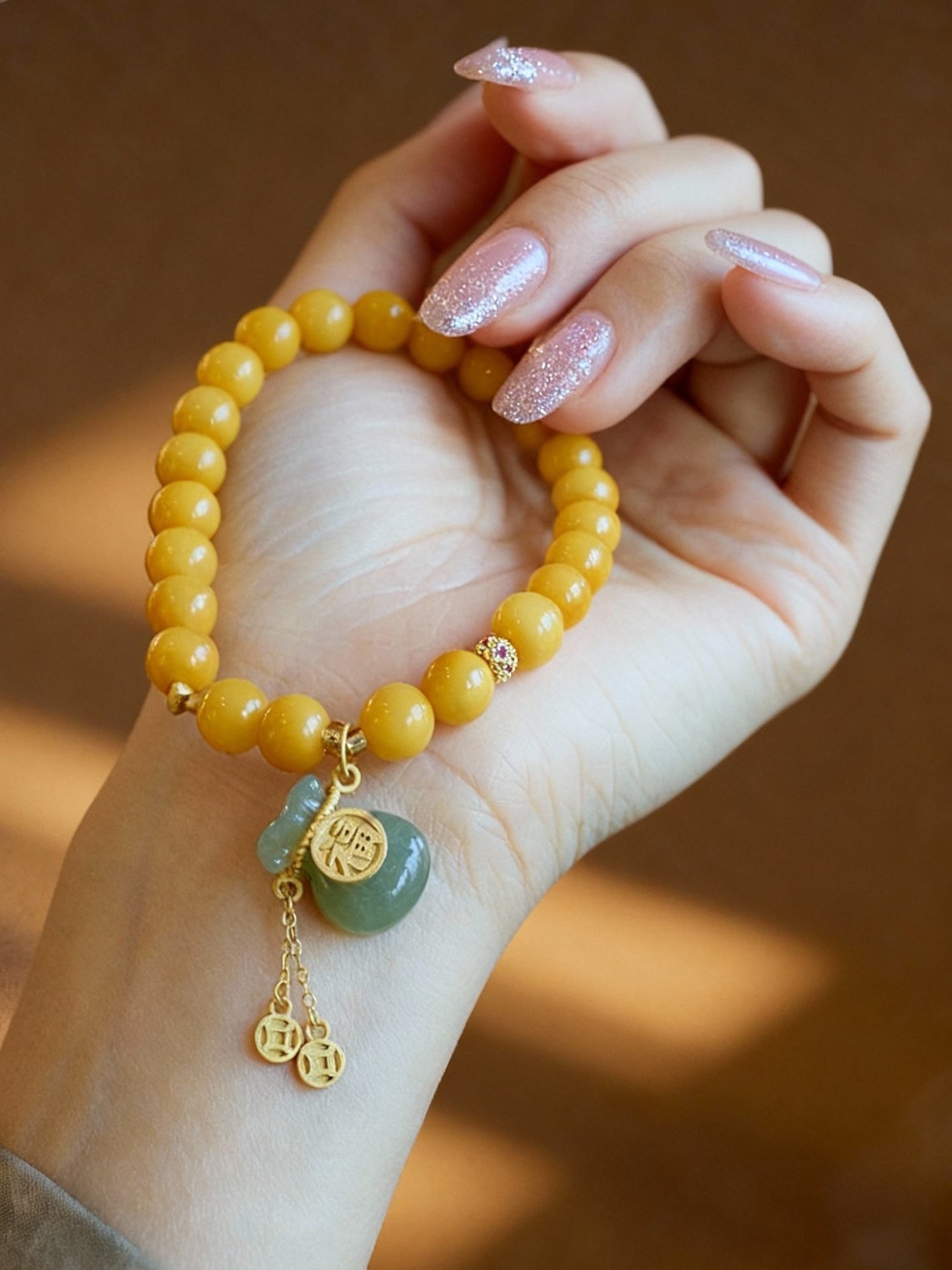 Natural amber and Hetian jade bracelet showing golden honey tones