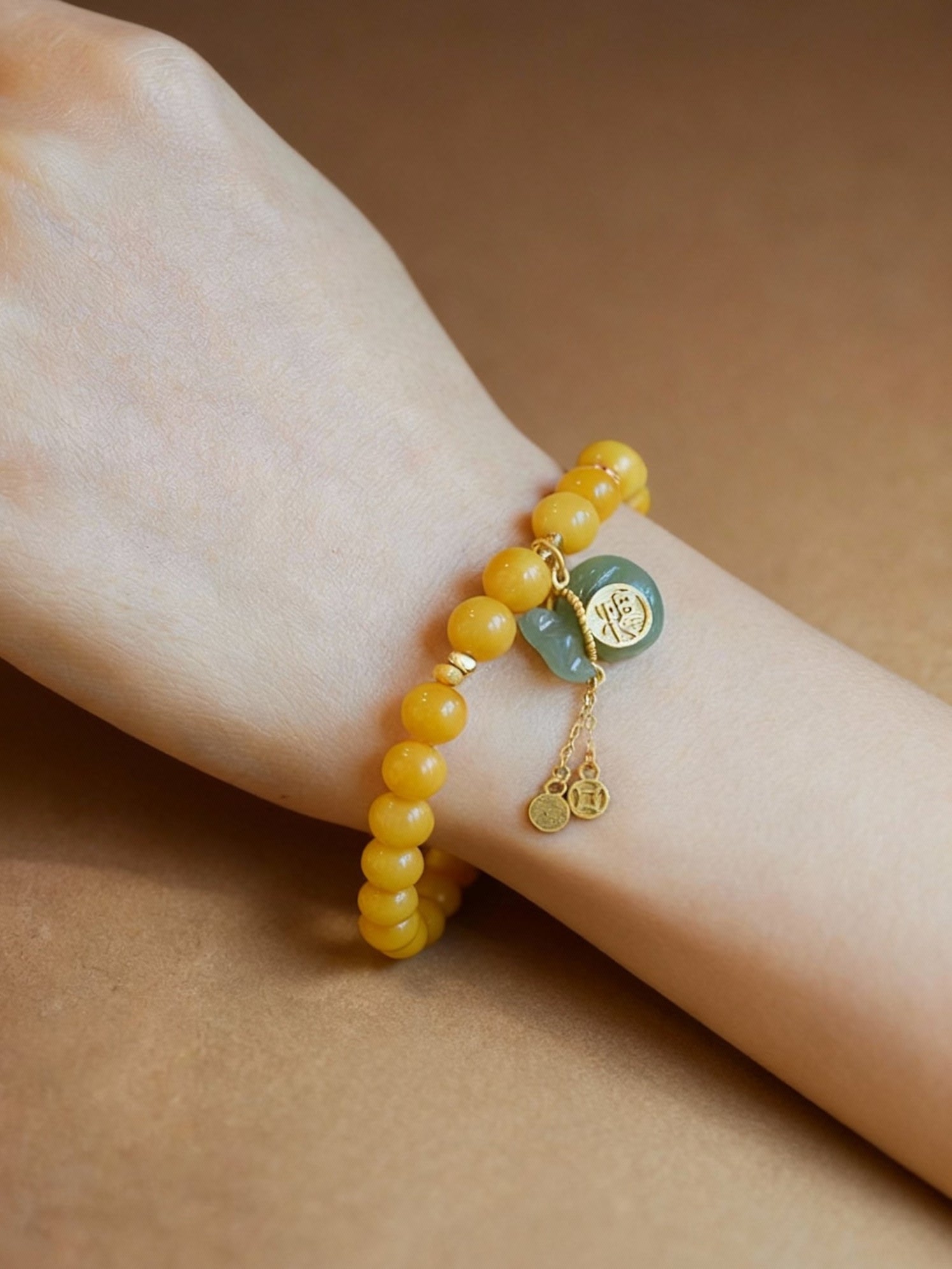 Amber crystal beaded bracelet with traditional jade pouch charm