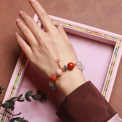 Model wearing colorful multi-gemstone bracelet with natural jadeite, Nan Hong agate and Hetian jade beads