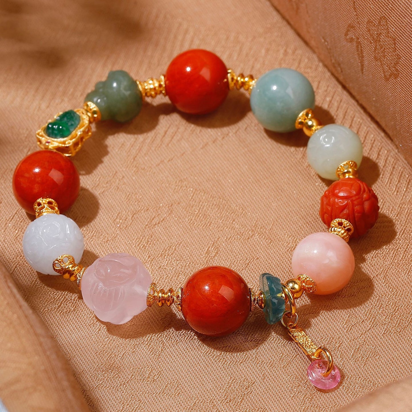 Natural green jadeite Pixiu charm with 24K gold-plated setting on handcrafted gemstone bracelet