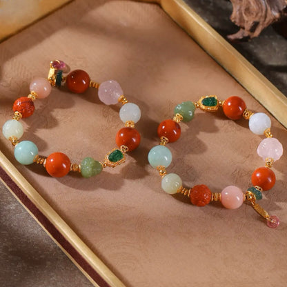 Natural rose quartz phoenix carving and white Hetian jade bead detail on lucky gemstone bracelet