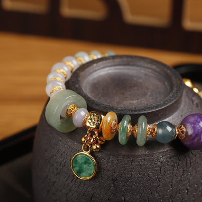Natural charoite bead with deep violet swirling patterns as centerpiece of handcrafted jadeite bracelet