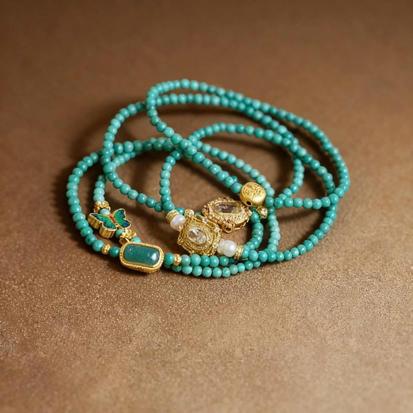 Turquoise beaded bracelet with decorative enamel butterfly