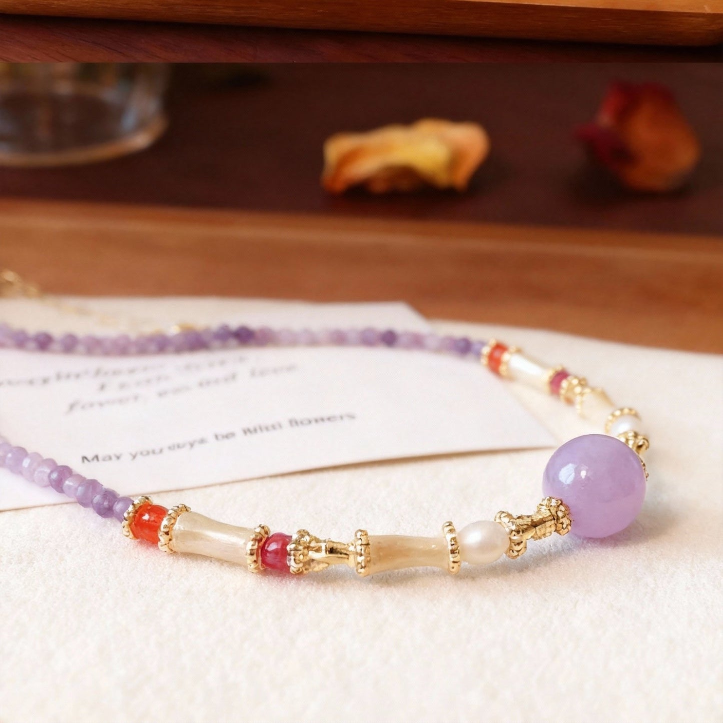 Detail of amethyst crystal necklace with pearl accents
