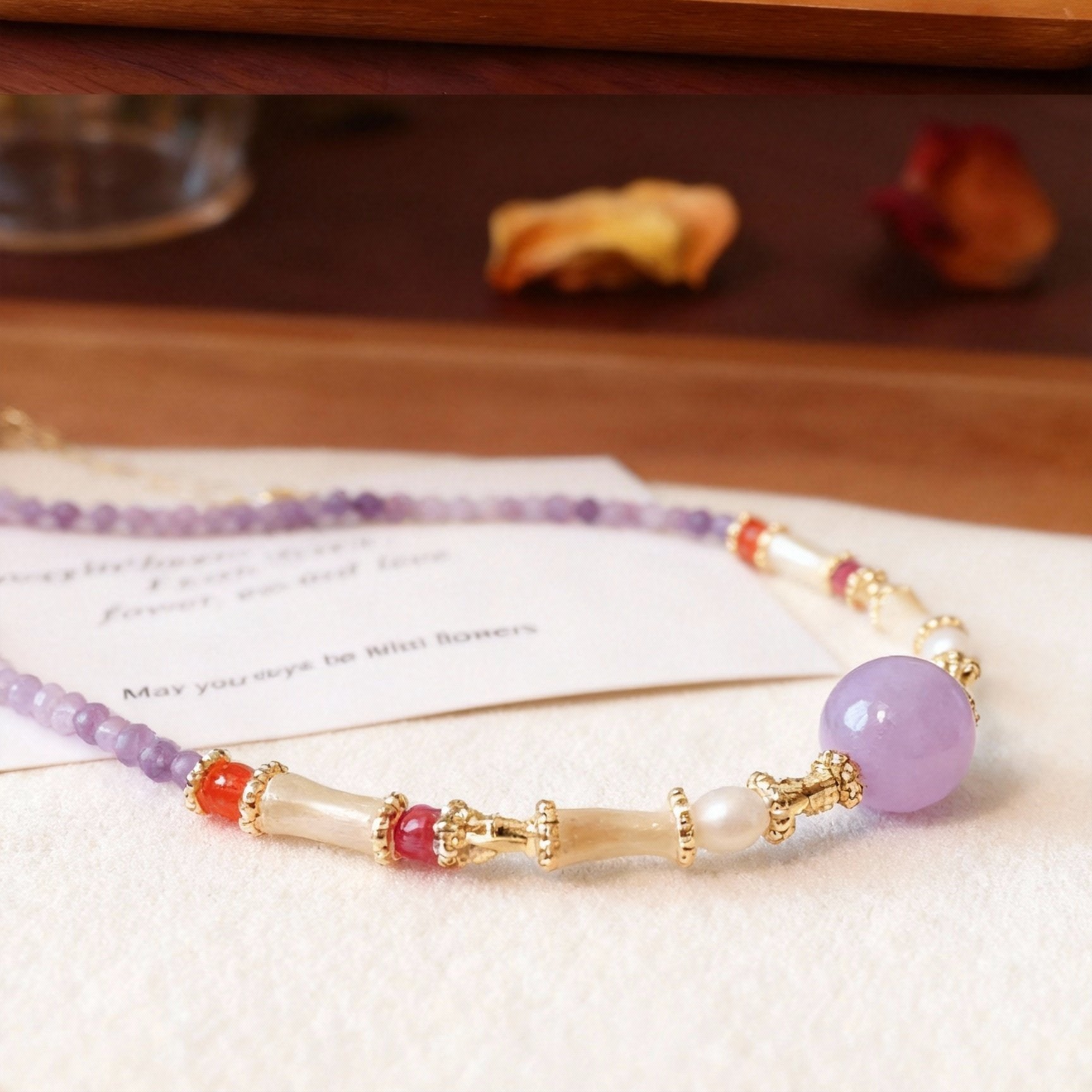 Detail of amethyst crystal necklace with pearl accents