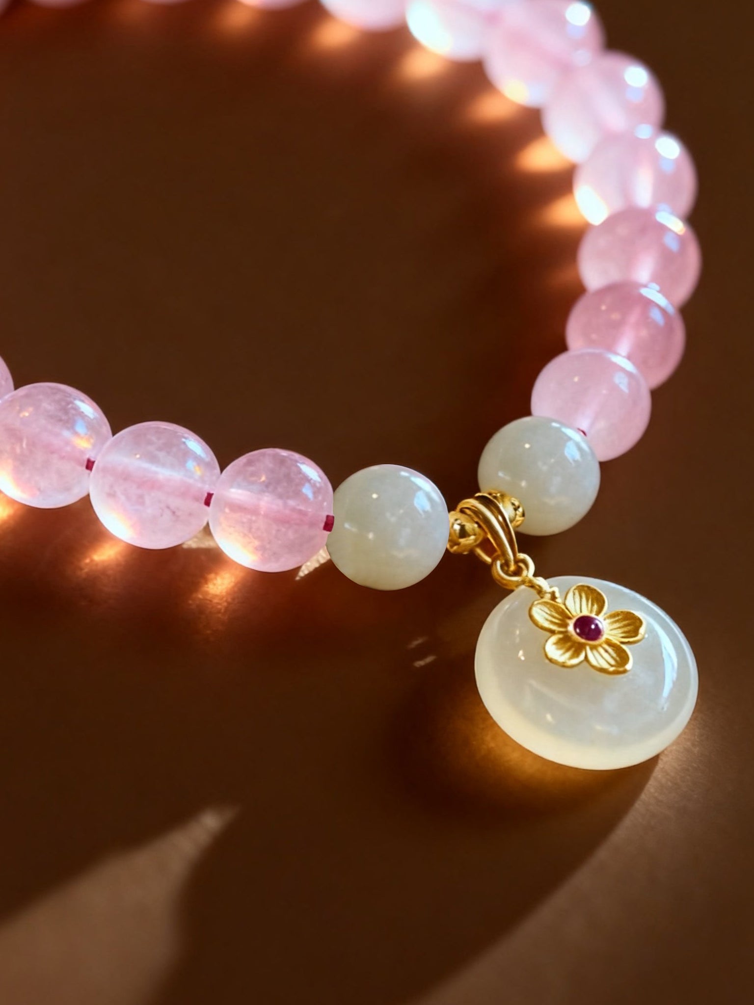 White jade and pink crystal bracelet with soft pastel tones