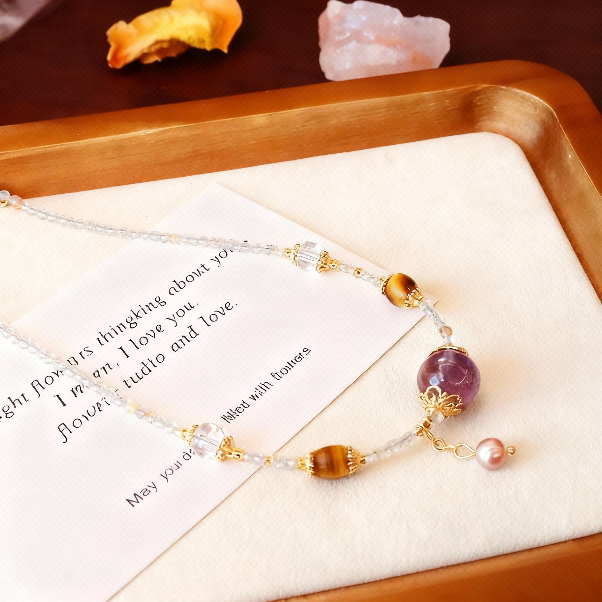 Detail of amethyst and clear quartz crystal necklace with pearls