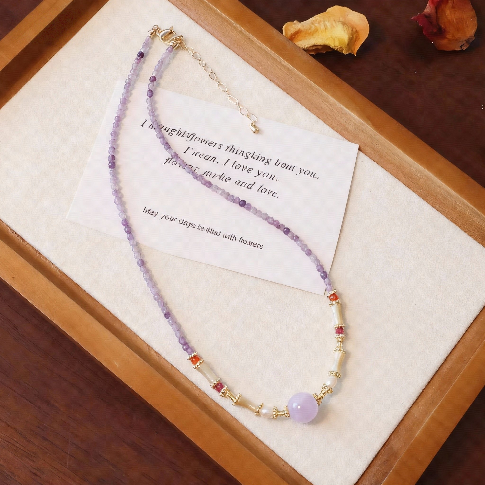 Close-up of purple amethyst and lavender crystal beads on necklace