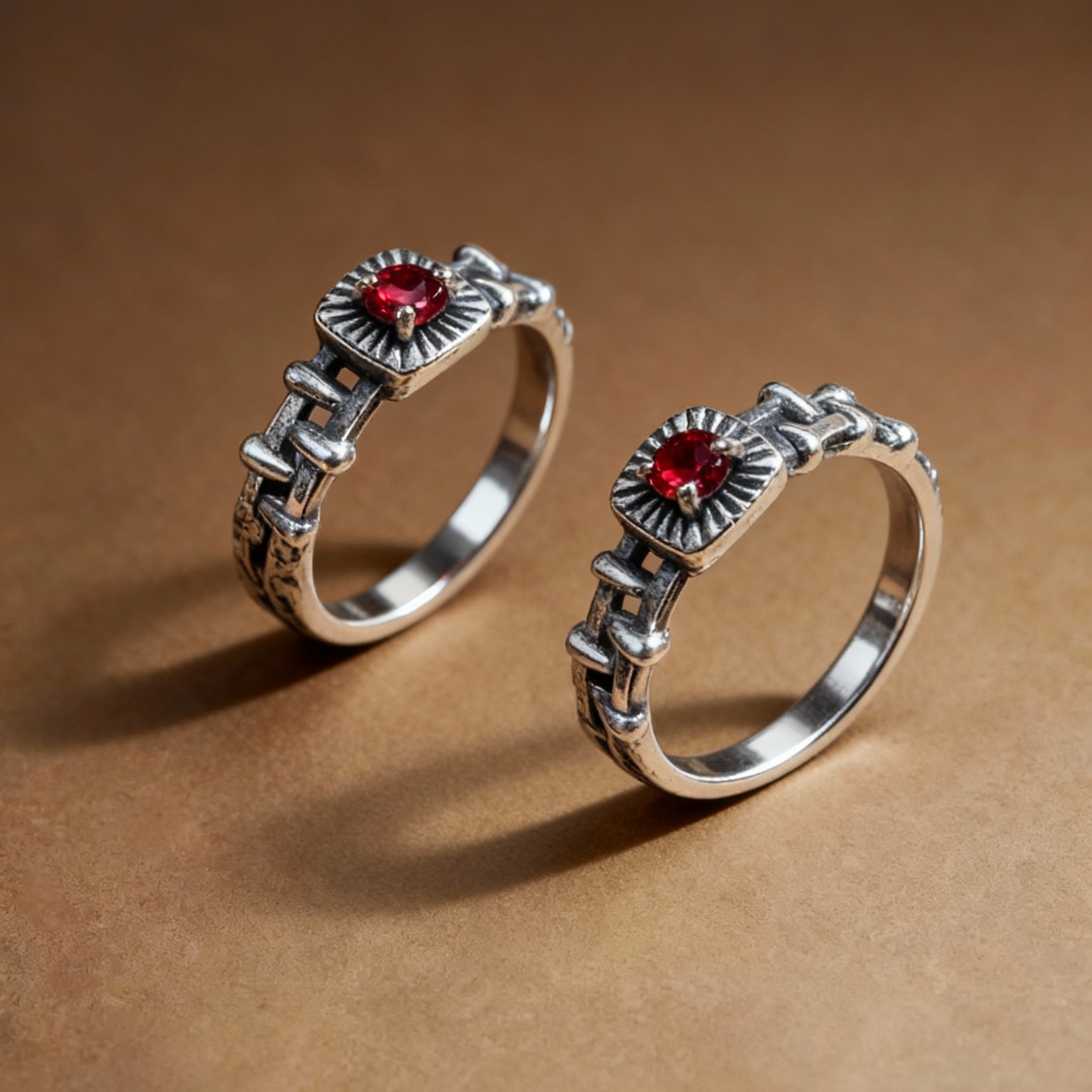 Close-up of red garnet gemstone on chain-link silver ring