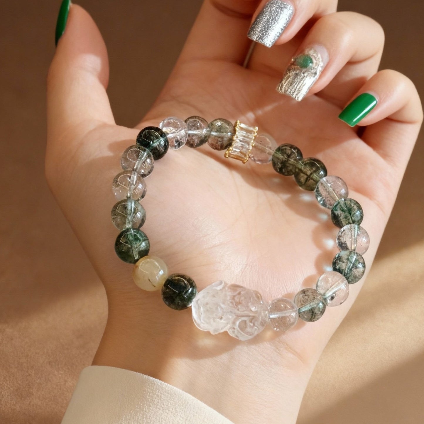 Detail of yellow jade Pixiu charm on phantom quartz bracelet