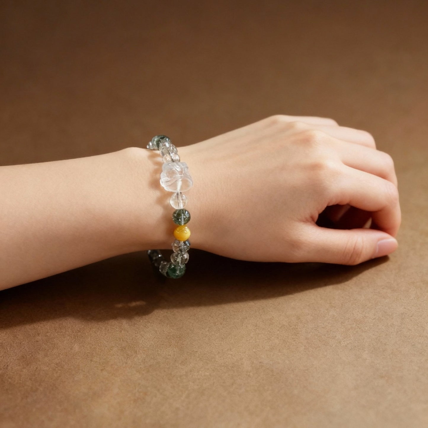 Close-up of green phantom quartz beads with lion dance pendant