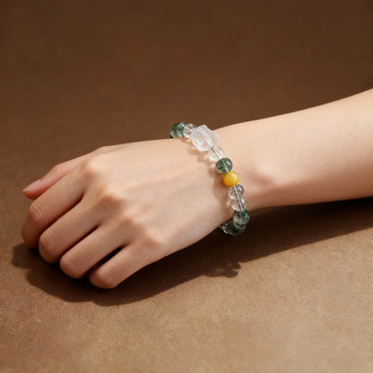 Detail of yellow agate lion dance charm on phantom quartz bracelet