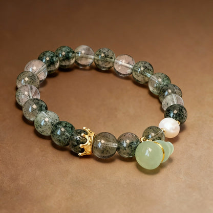 Detail of serpentine jade gourd pendant on phantom quartz bracelet