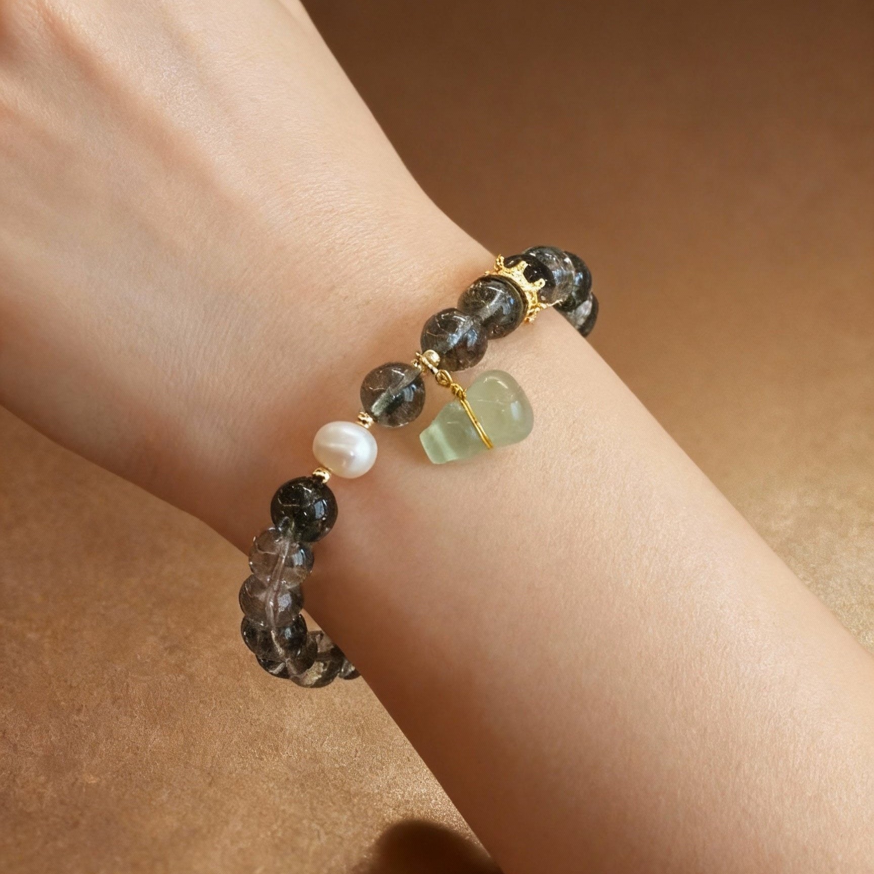 Phantom quartz bracelet showing green inclusions with serpentine gourd