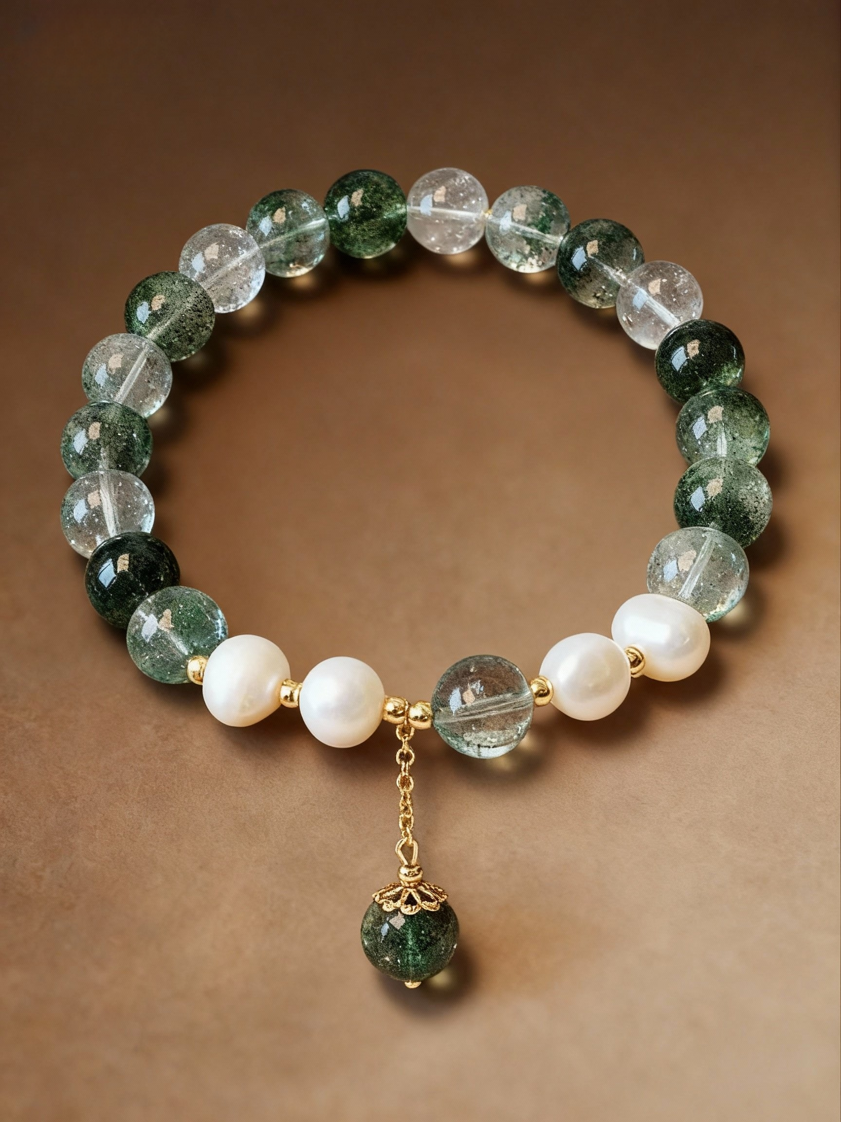 Detail of phantom quartz crystal and pearl beaded bracelet