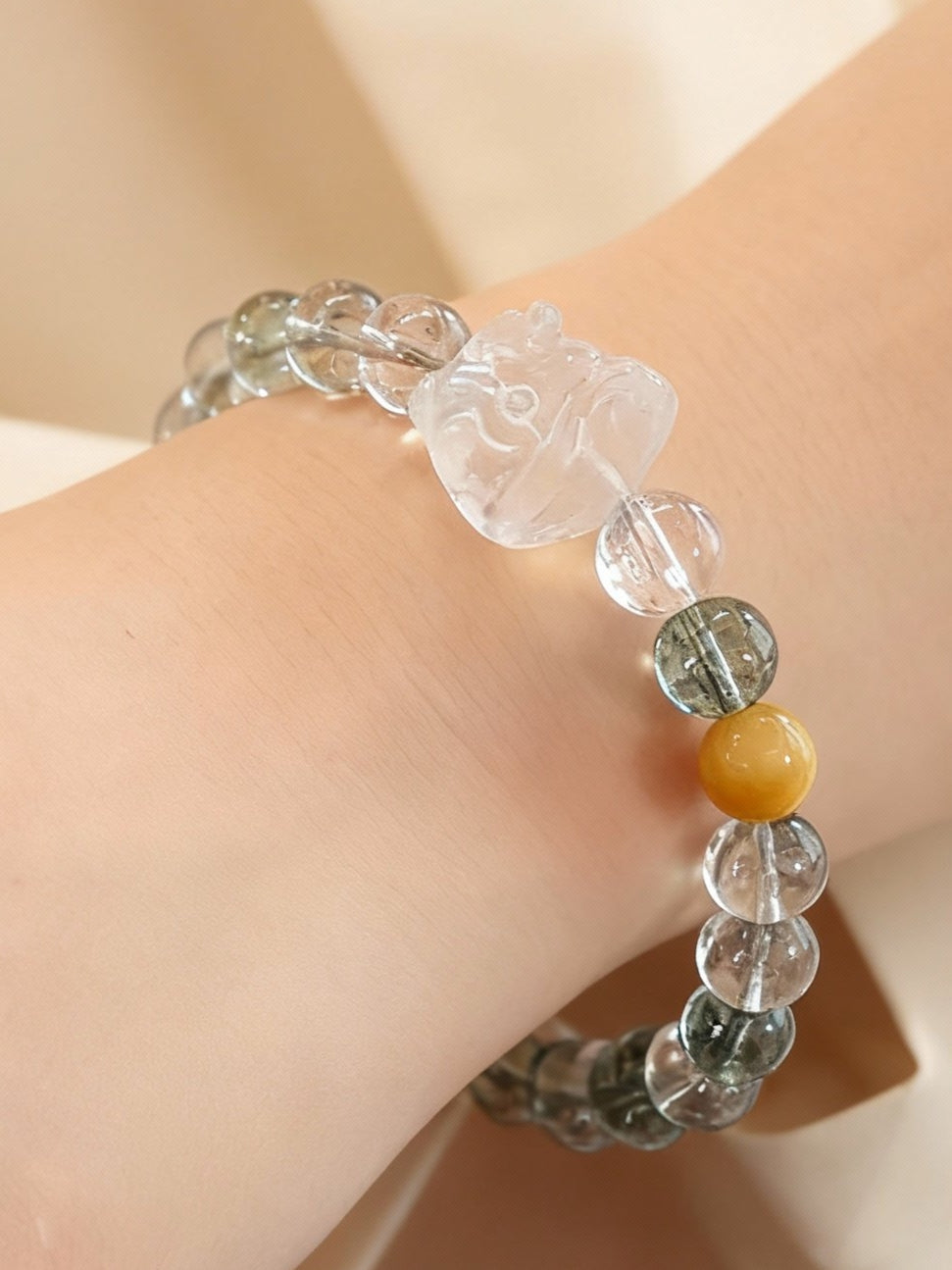 Phantom quartz bracelet showing green inclusions with lion dance pendant