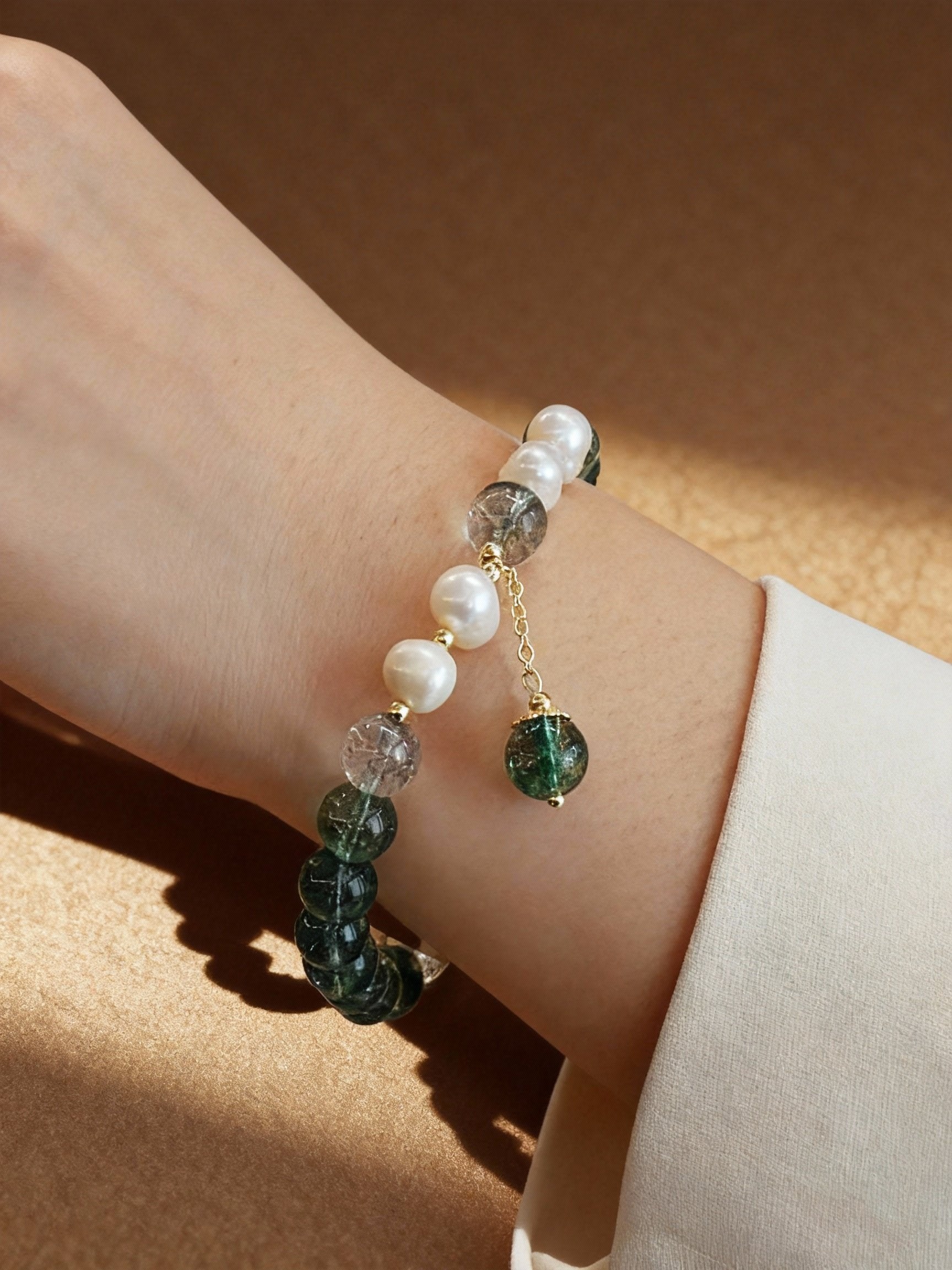 Green phantom quartz bracelet showing natural inclusions and pearls