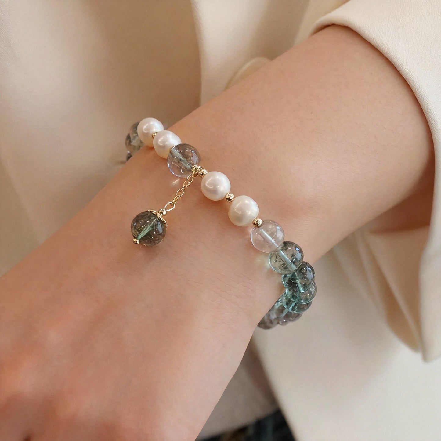 Close-up of green phantom quartz beads with white pearl accents