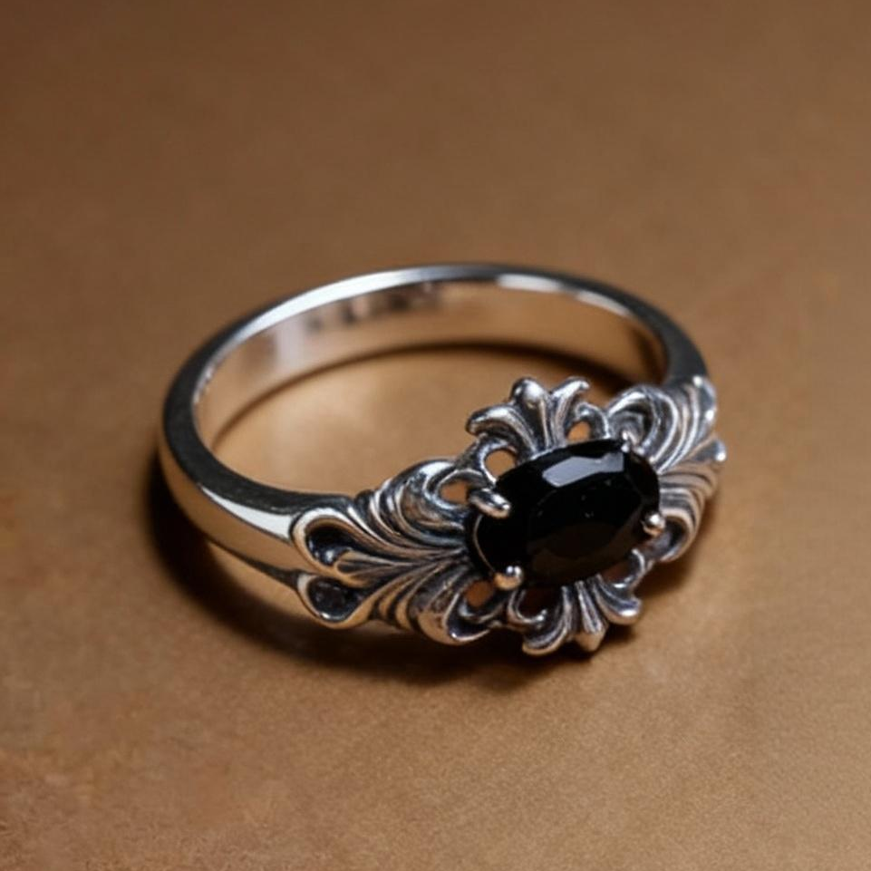 Close-up of oval-cut black spinel gemstone on silver ring