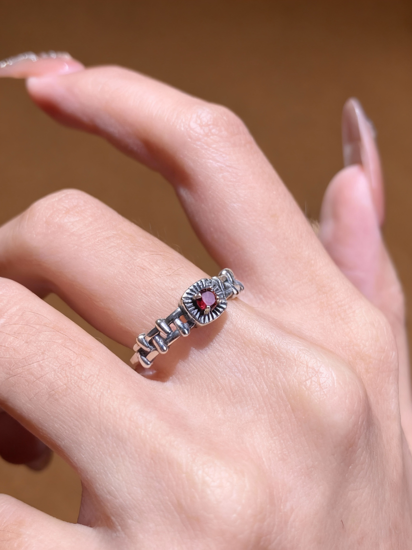 Sterling silver chain-link ring with natural garnet gemstone