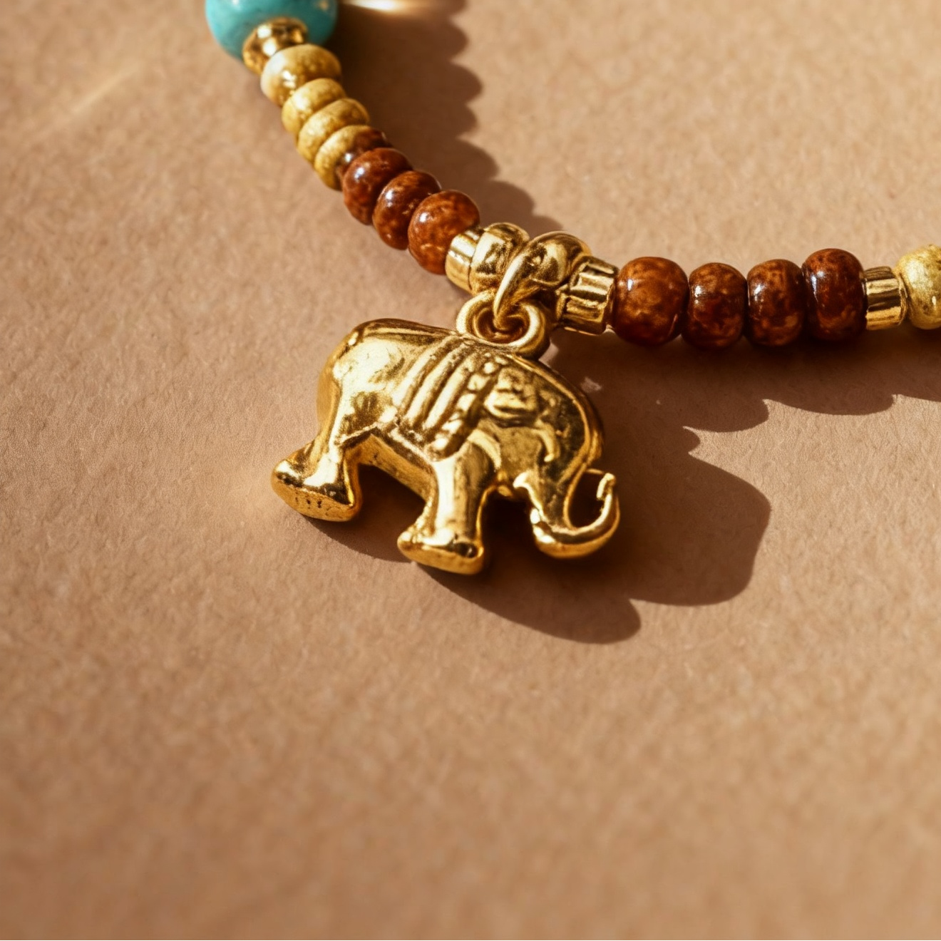 Close-up of elephant pendant with colorful mixed gemstone beads