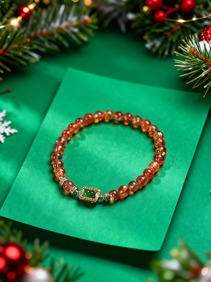 Close-up of orange sunstone beads with jade gourd charm