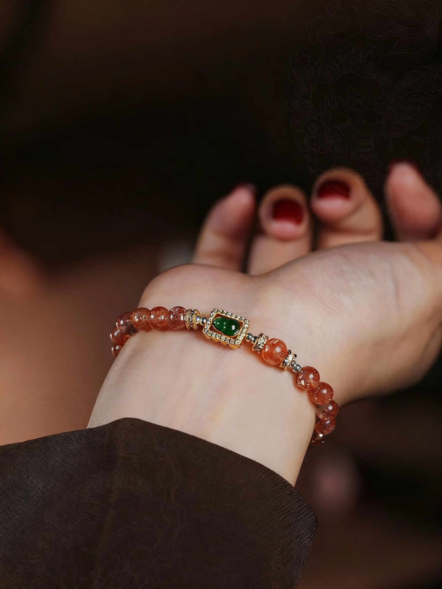 Detail of jade gourd charm on sunstone bracelet