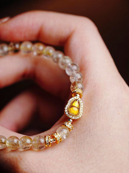 Golden rutile inclusions in clear quartz crystal beads