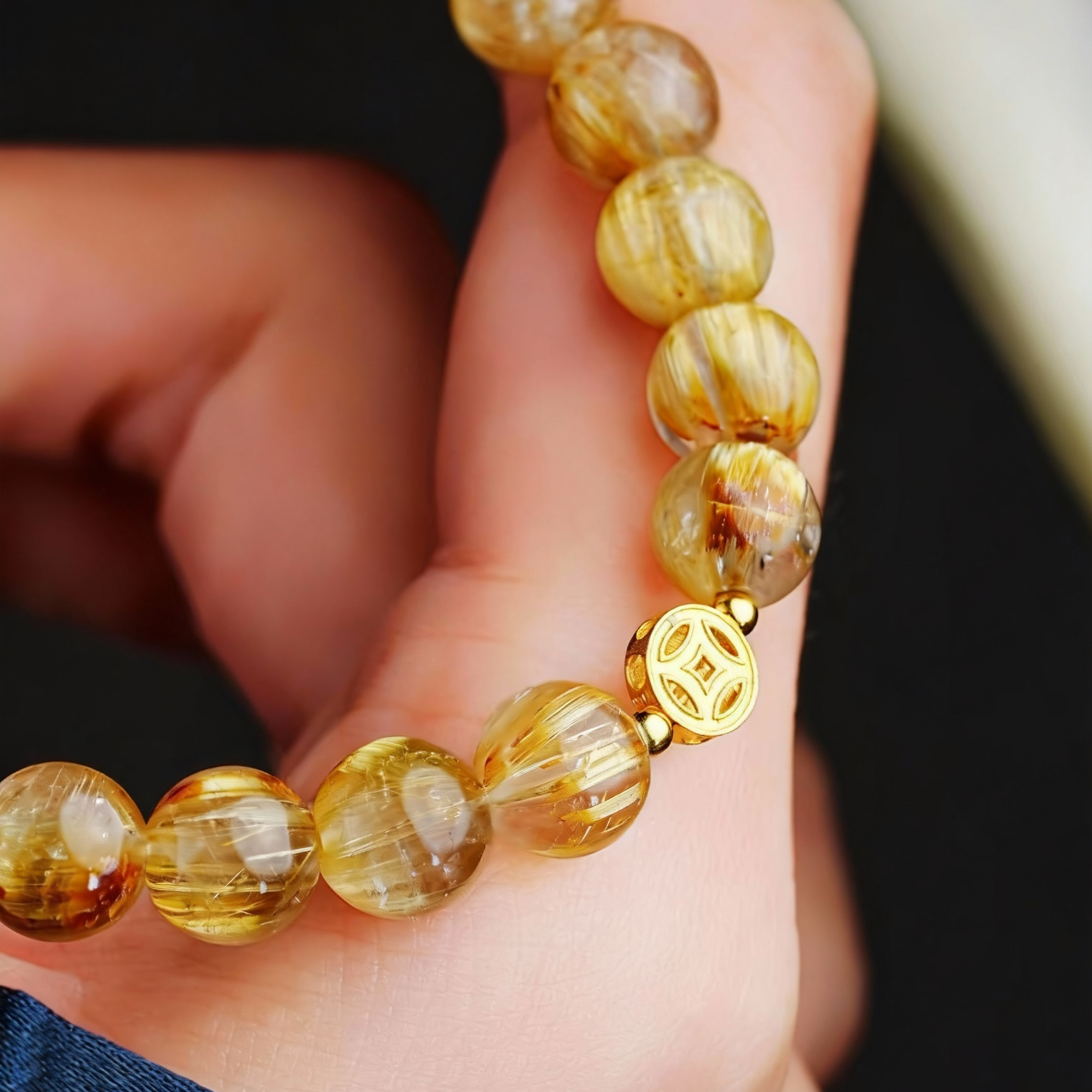 Handcrafted rutilated quartz bracelet with fortune coin charm