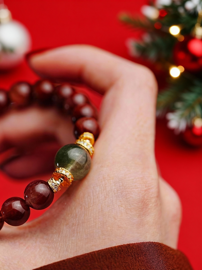 Red rabbit hair and green rutilated quartz bracelet flat lay