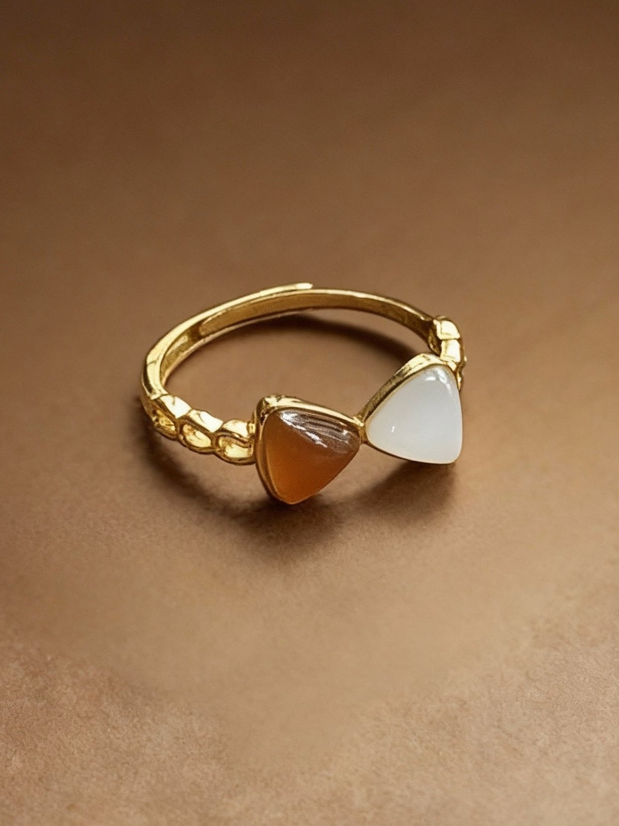 Close-up of two-tone jade ring showing white and green colors