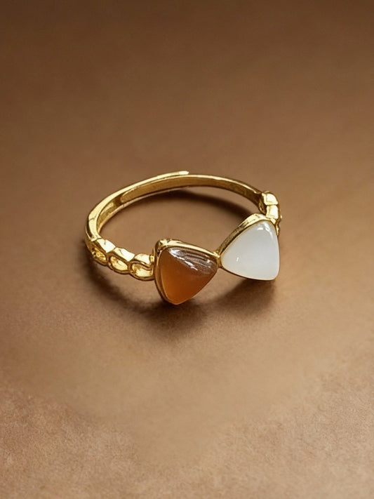 Close-up of two-tone jade ring showing white and green colors