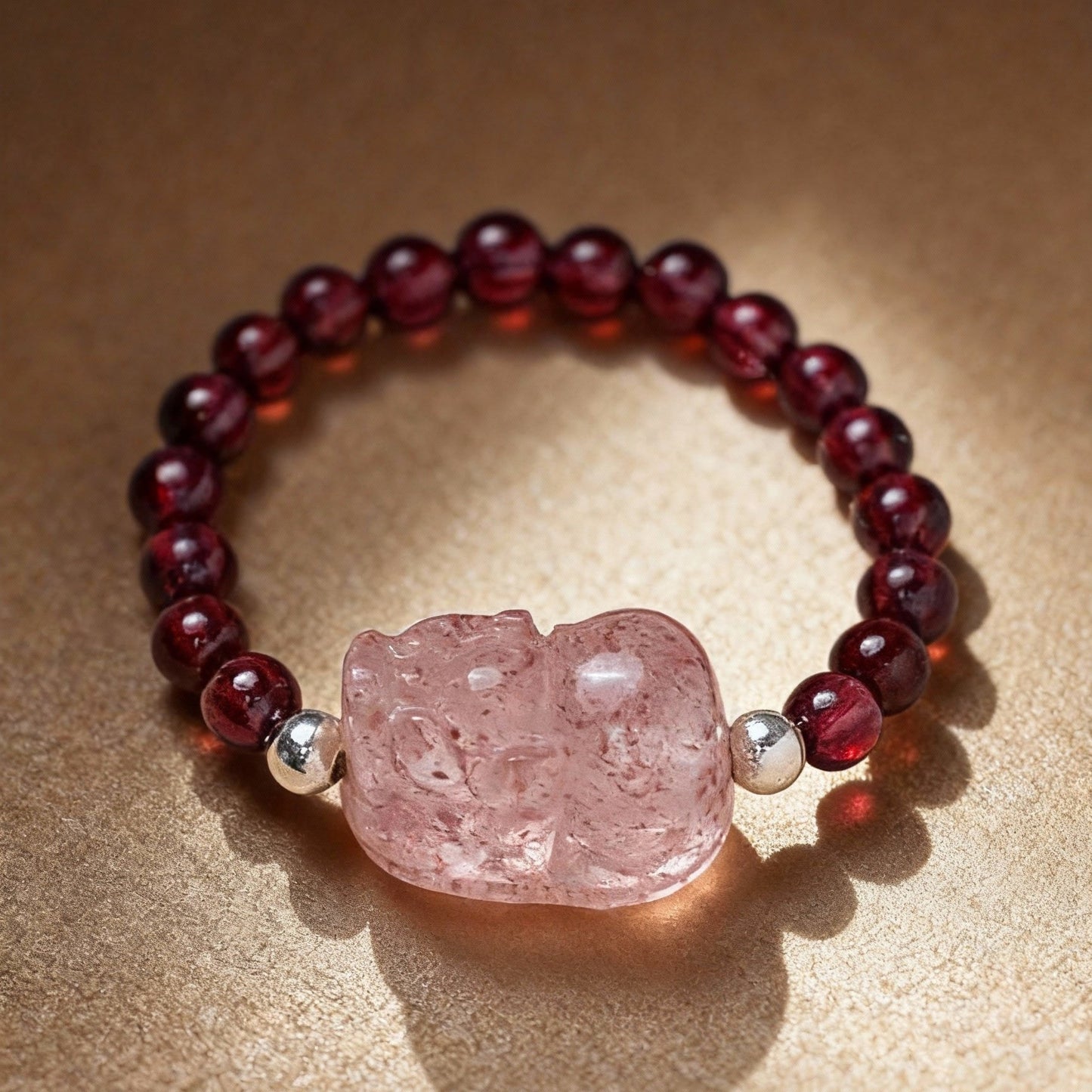 Close-up of tourmaline ring with Pixiu charm and garnet stones