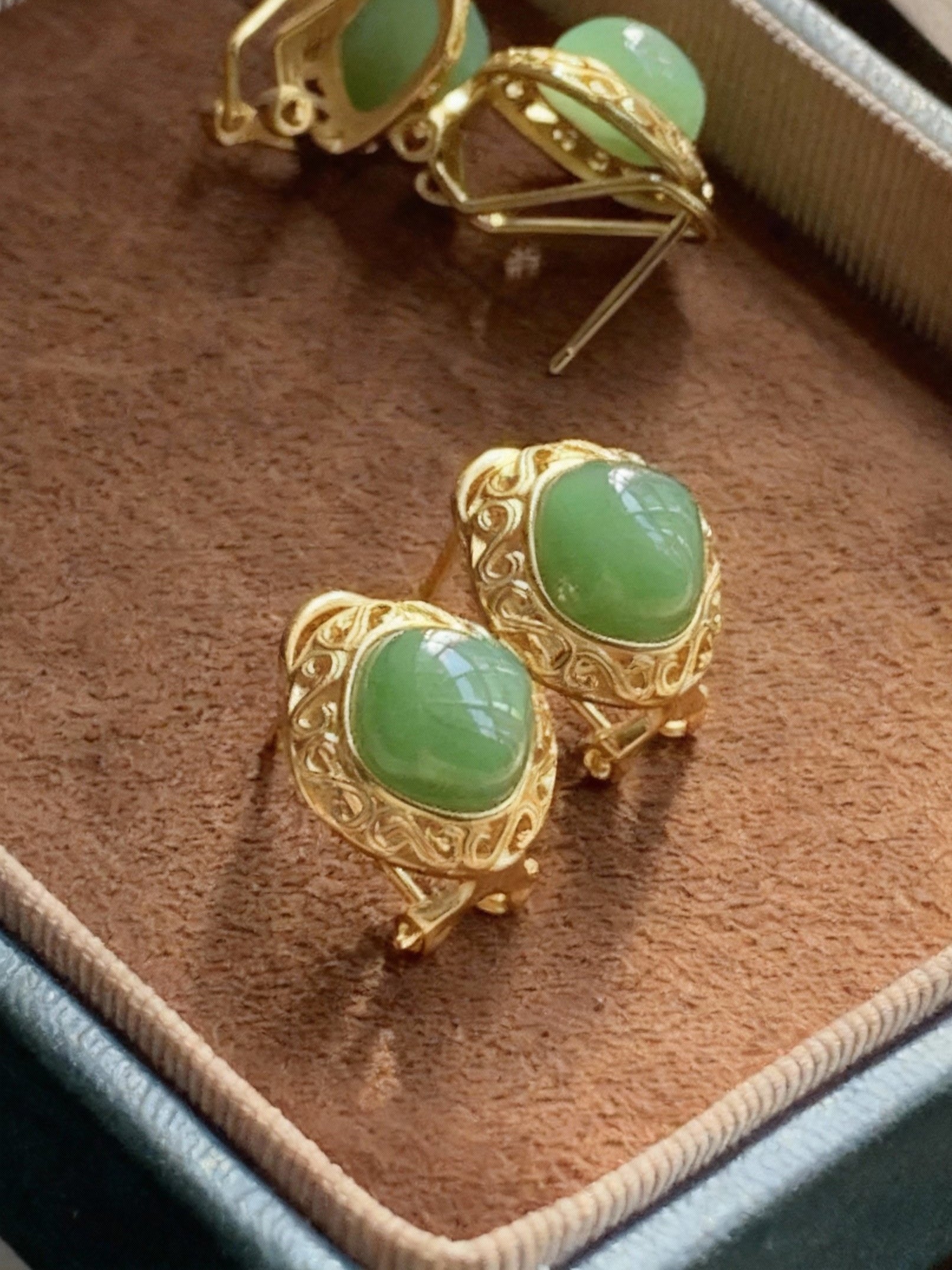Green nephrite jade earrings showing natural stone quality
