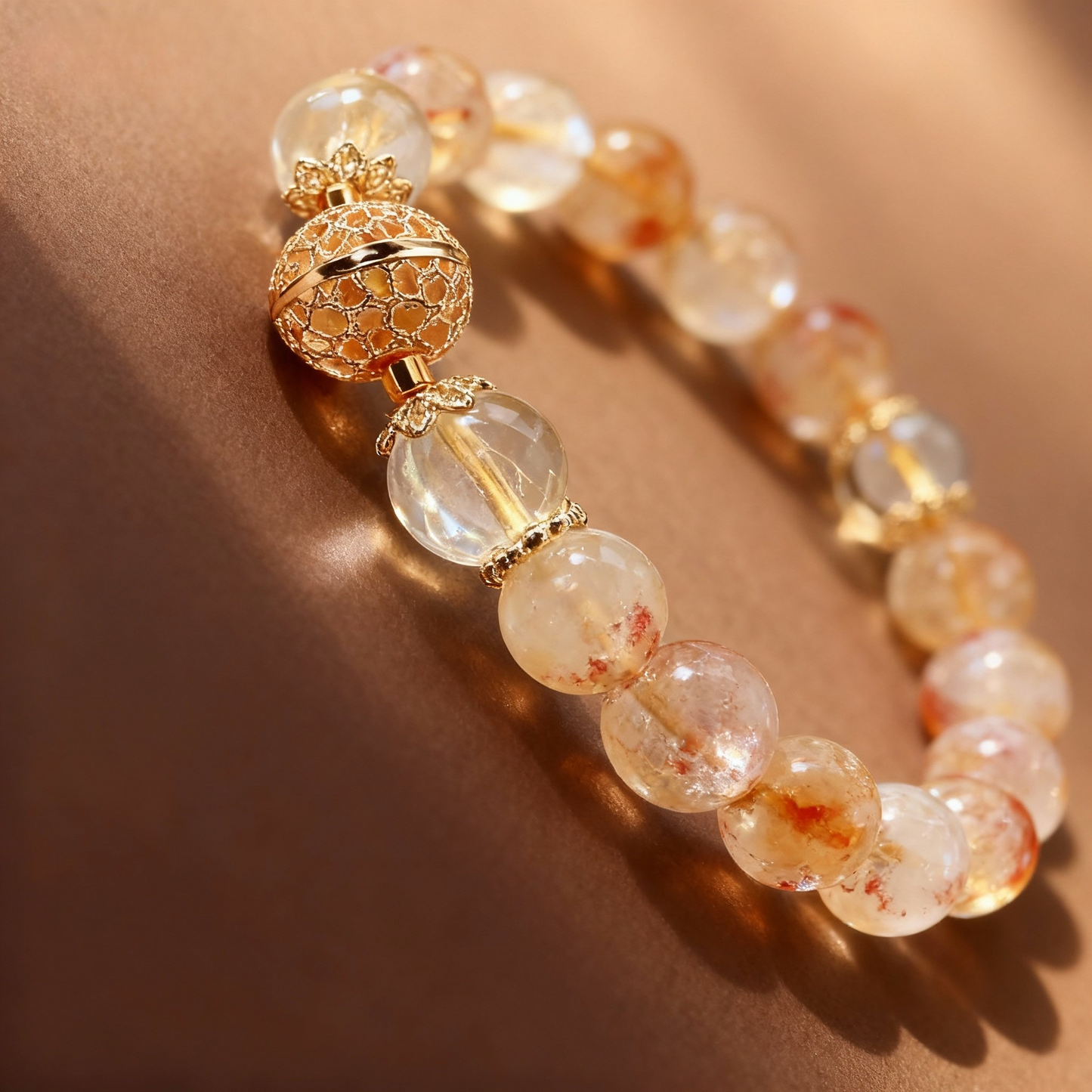 Detail of rutilated quartz bracelet with exquisite metal ball charm