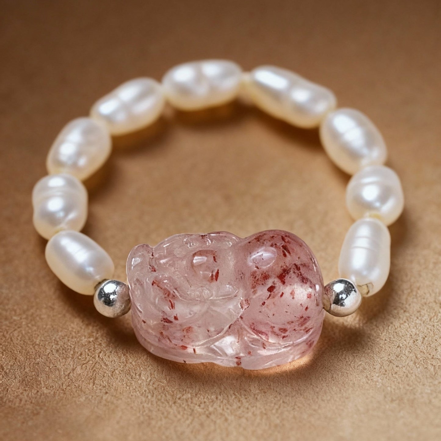 Close-up of tourmaline ring with Pixiu charm and white pearls