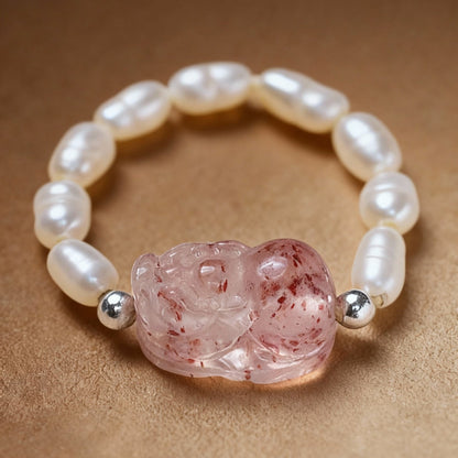 Close-up of tourmaline ring with Pixiu charm and white pearls