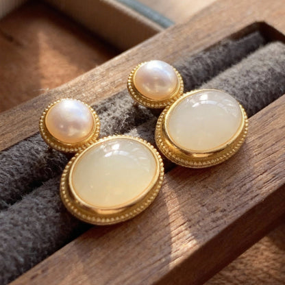 Close-up of jade and pearl earrings showing natural materials