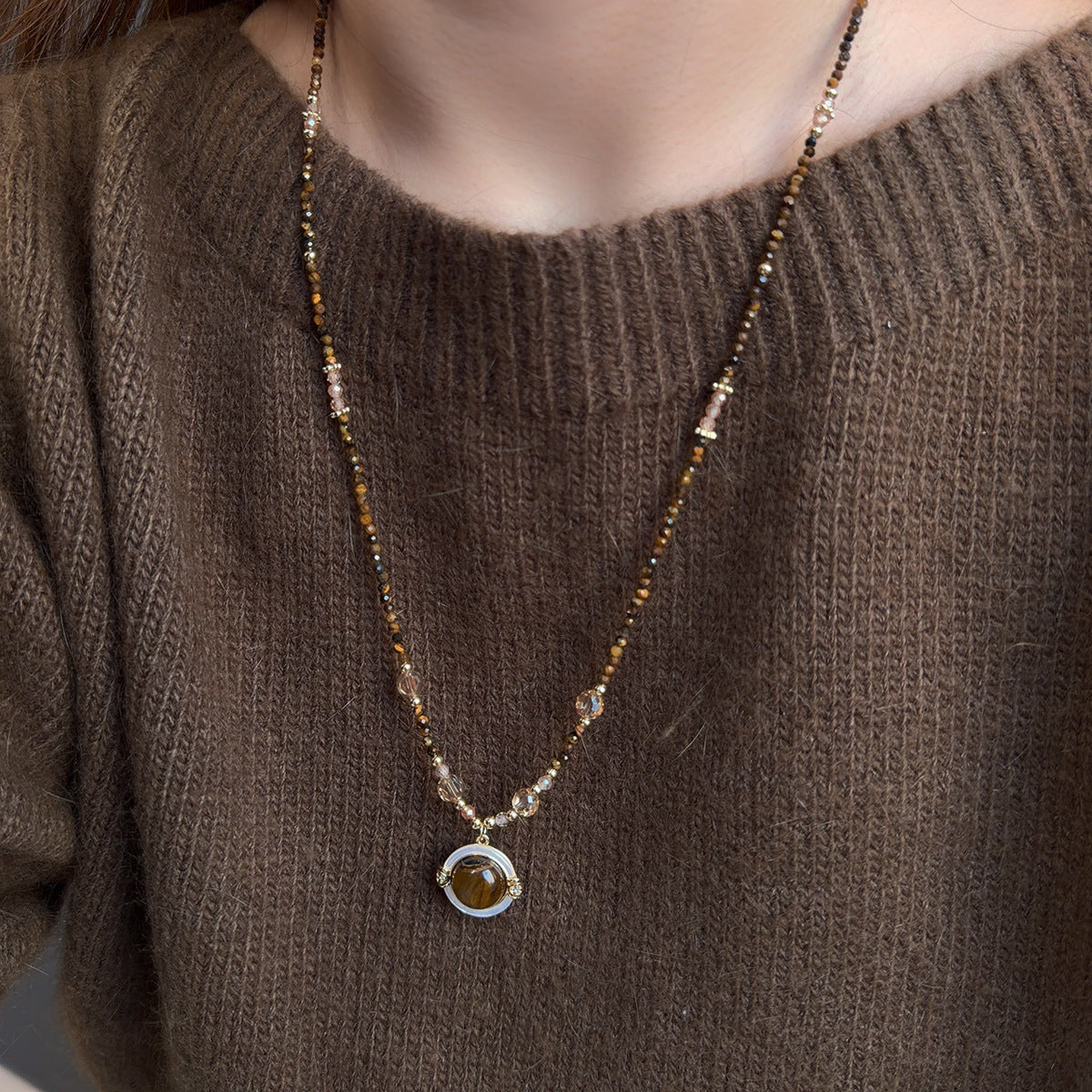 Tiger eye and mother-of-pearl sweater chain showing natural materials