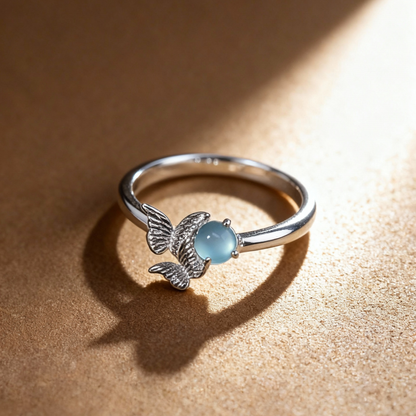 Detail of angel wing design with blue and green gemstones