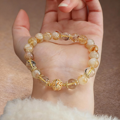 Golden rutilated quartz wealth bracelet with metal accent