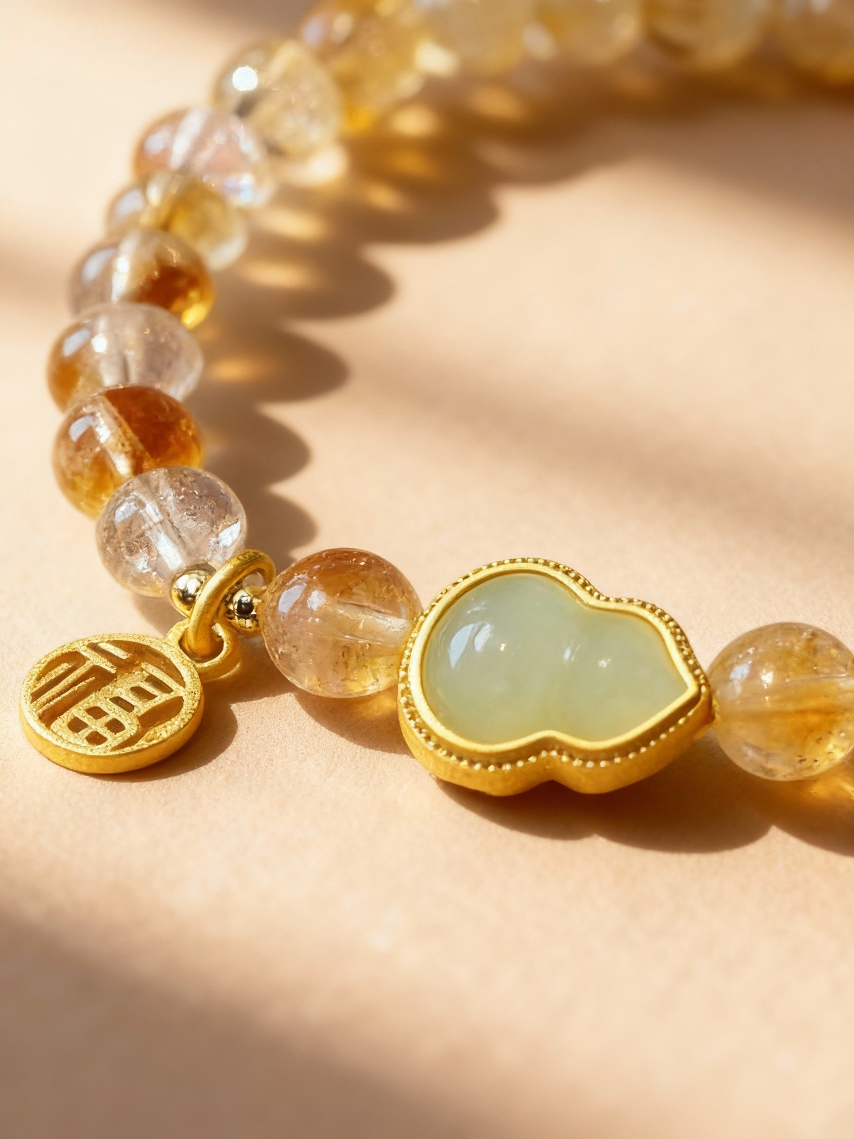 Citrine beaded bracelet showing golden yellow color and jade gourd