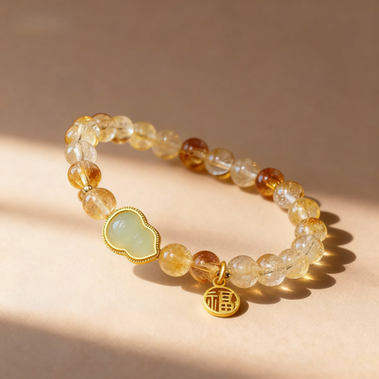 Close-up of citrine beads with green jade gourd fortune charm
